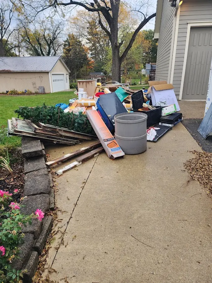 Dumpster being loaded with debris for Roofing Dumpster Rental in Fremont